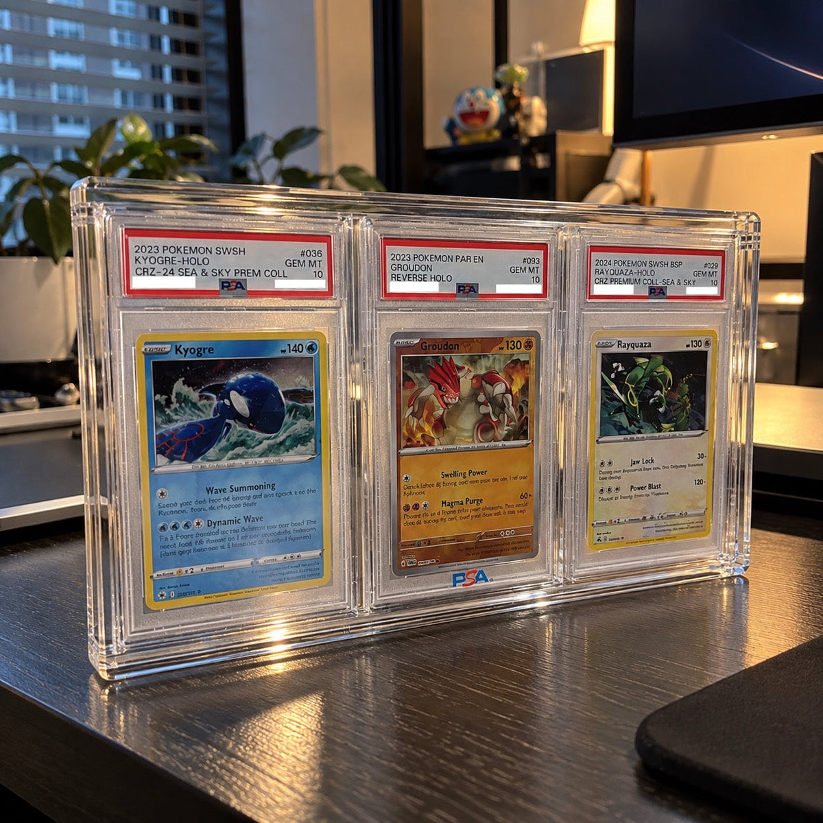 Three PSA-graded Pokemon slabs side by side in a GX 3 Row Slab Display